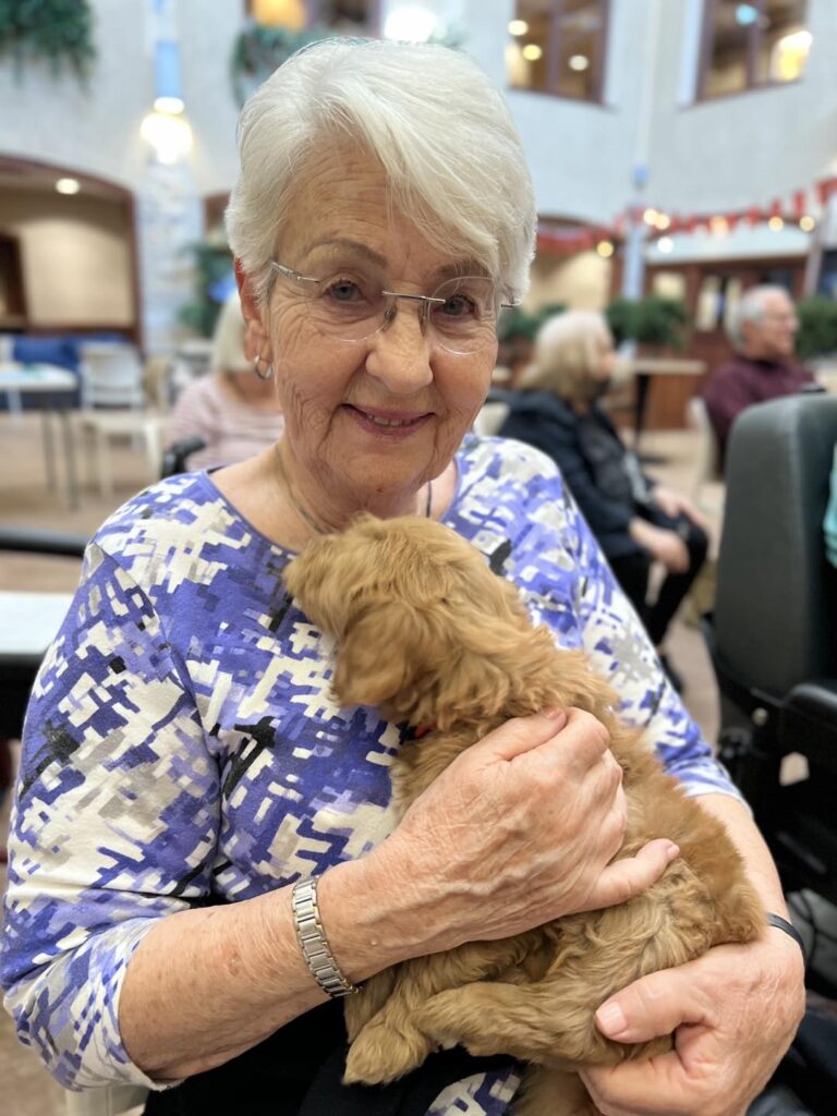 Teal Shores Senior Resident at Pet Therapy Event