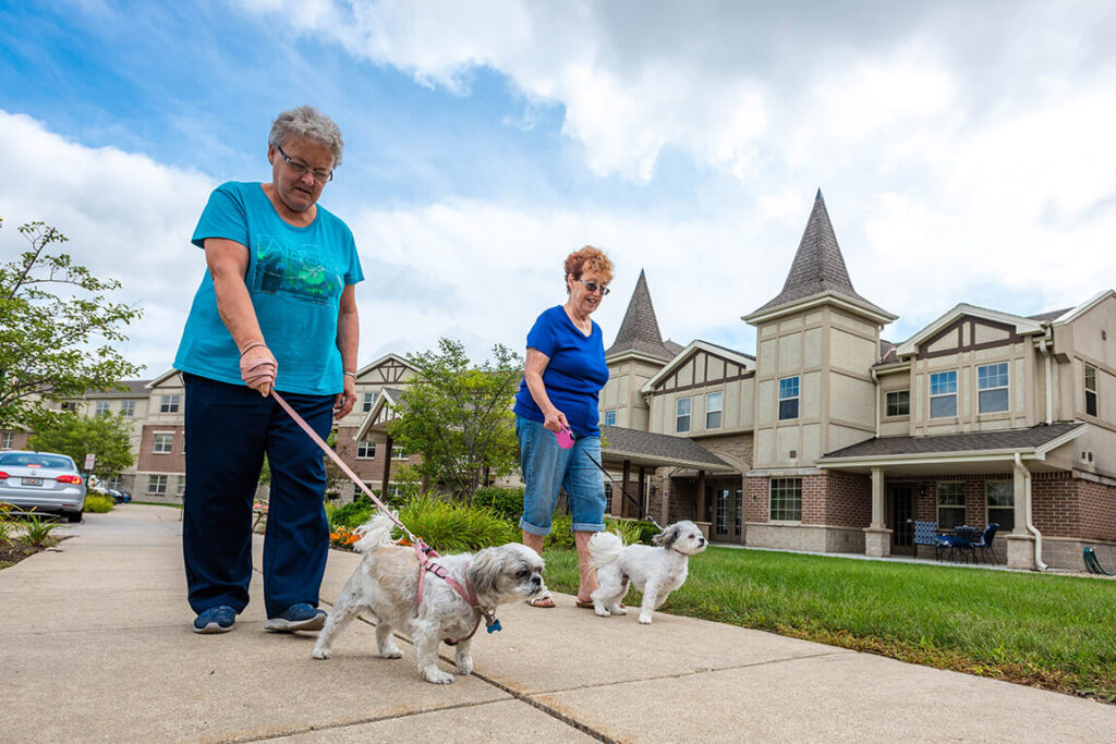 Residents Walking Dog At Gables of Germantown, WI